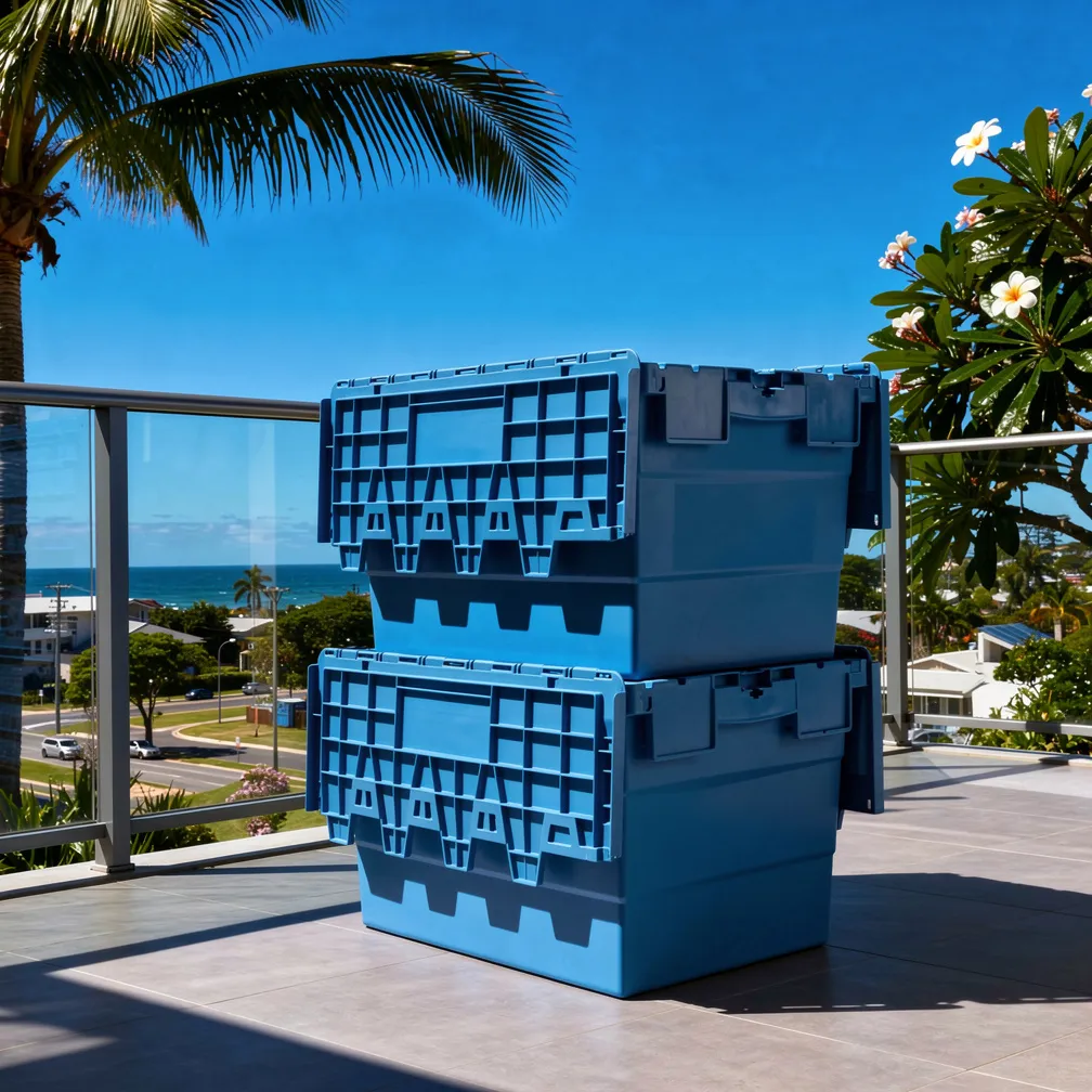 Heavy-duty plastic moving crates stacked on a Gold Coast balcony with ocean views
